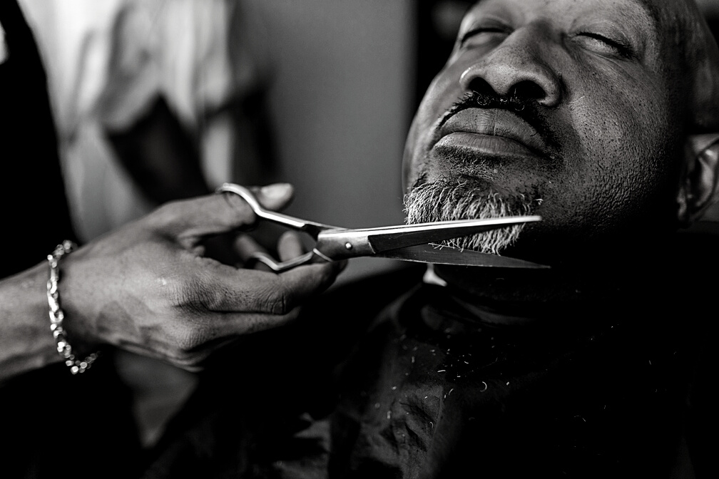Person Cutting Man's Beard